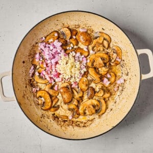 sautéed mushrooms with shallot and garlic in a pan.