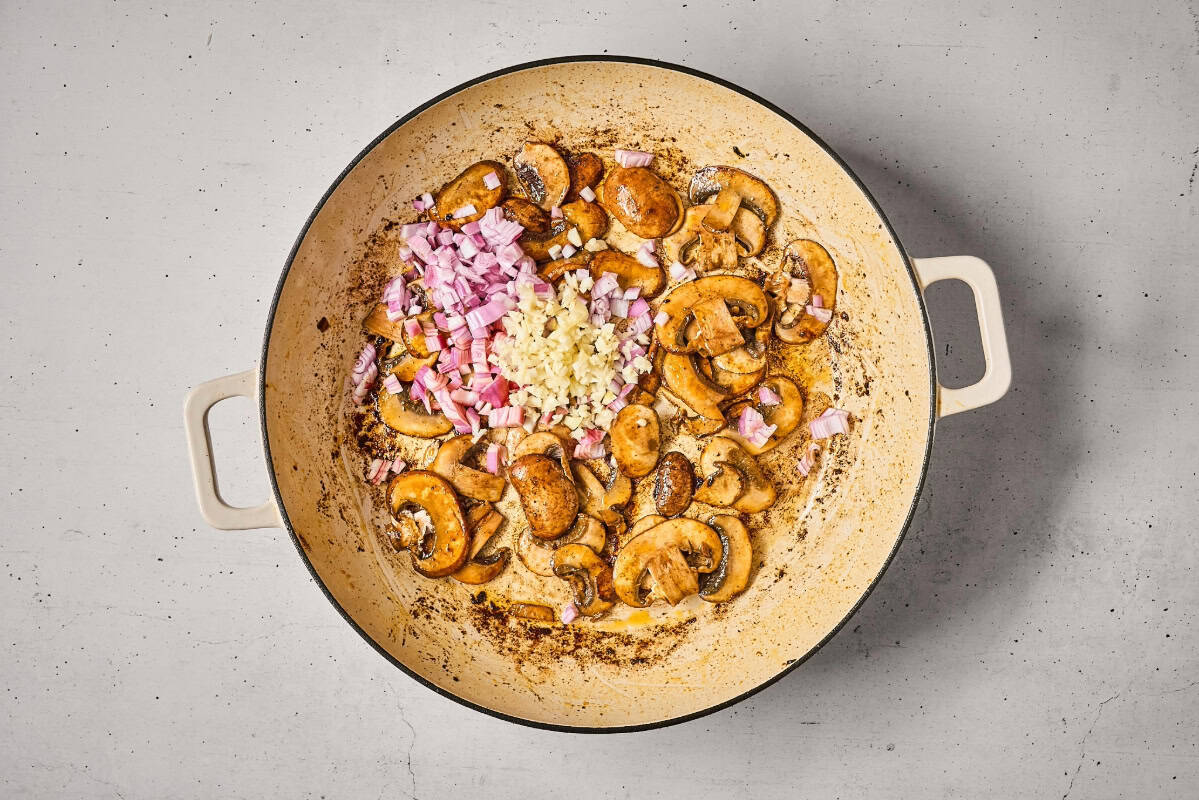 sautéed mushrooms with shallot and garlic in a pan.