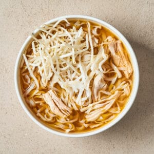 a bowl of chicken pho with bean sprouts.