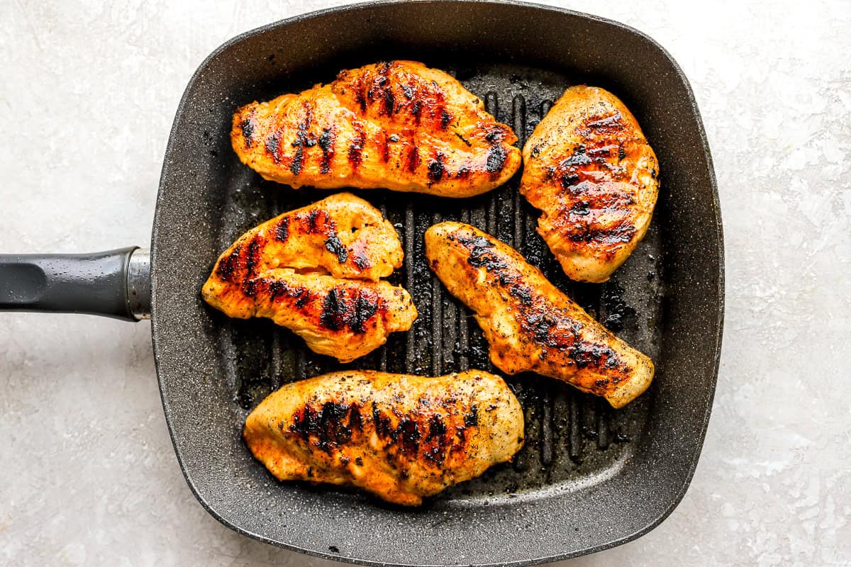 grilled marinated chicken breasts in a grill pan.