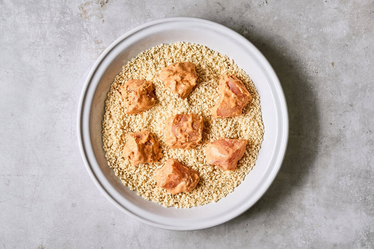 Dredging bites of chicken in Panko breadcrumbs.