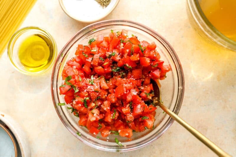 chopped bruschetta mixture in a glass bowl.