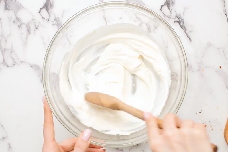 Mixing yogurt marinade in a bowl.