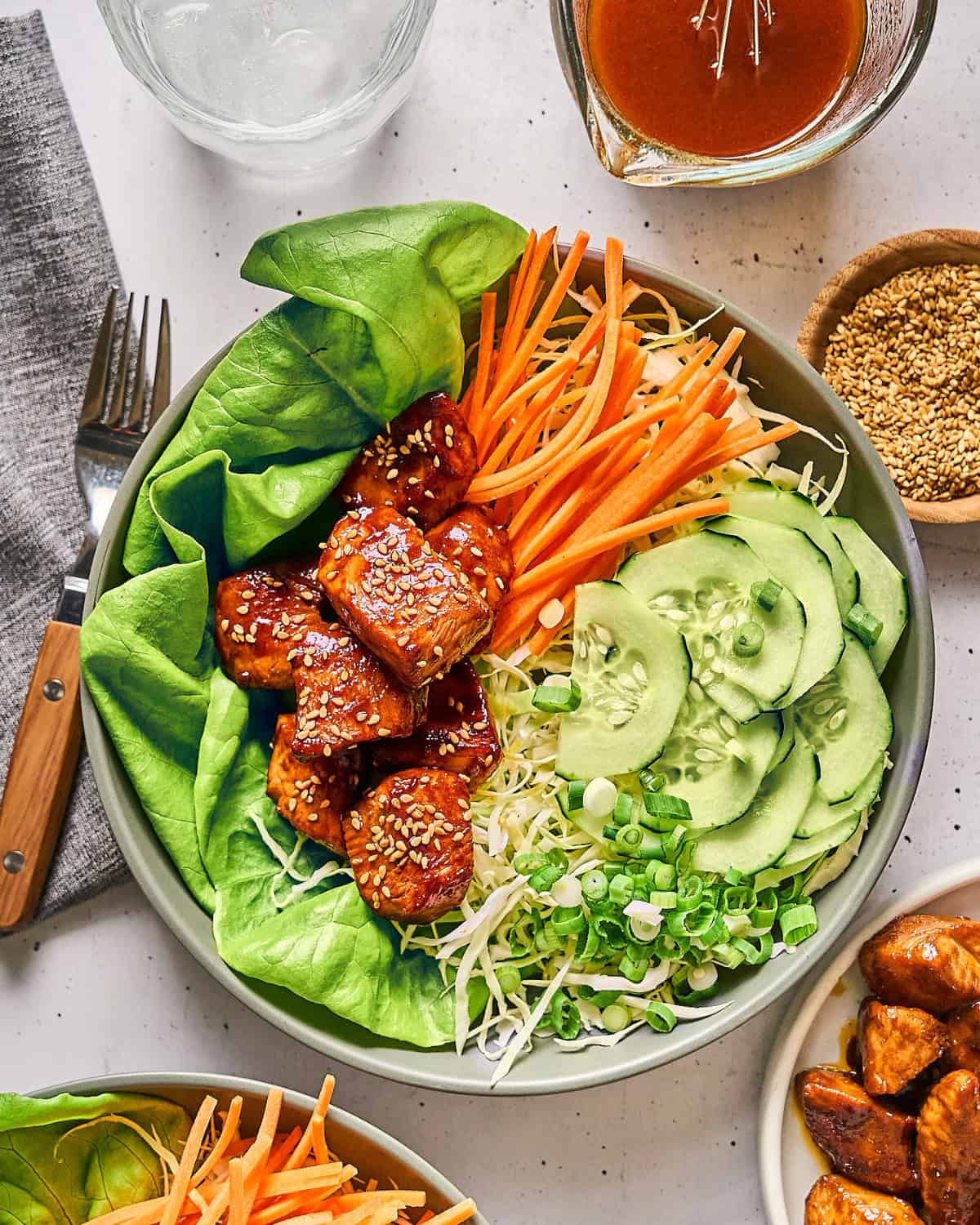 overhead view of a serving korean bbq chicken salad in a bowl.