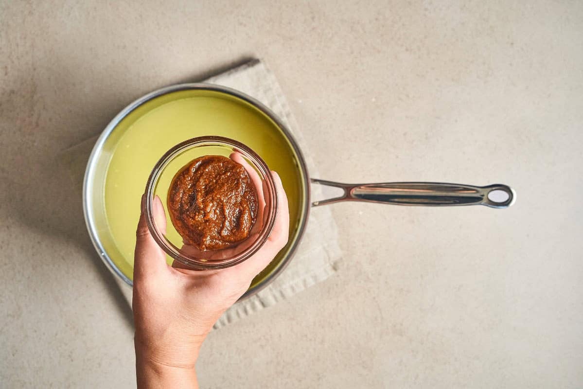 pho soup paste in a small bowl over a pot.