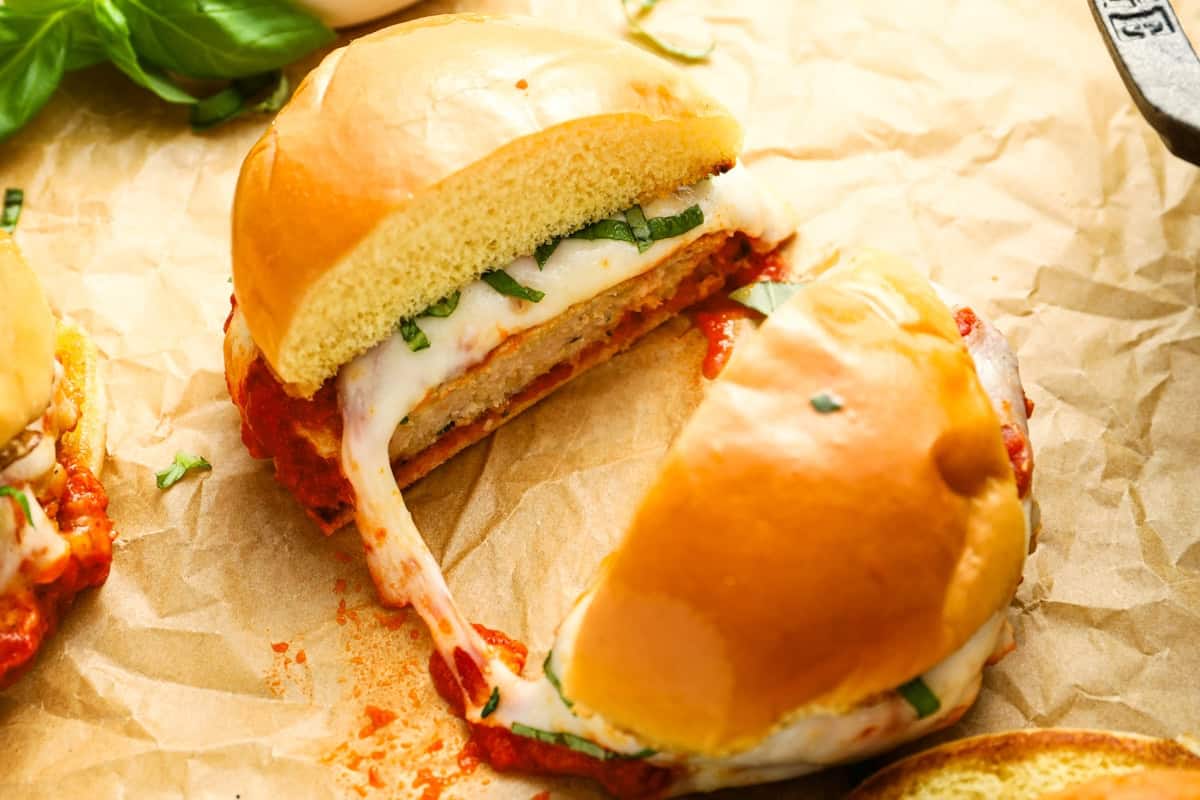 A chicken parm burger cut in half.