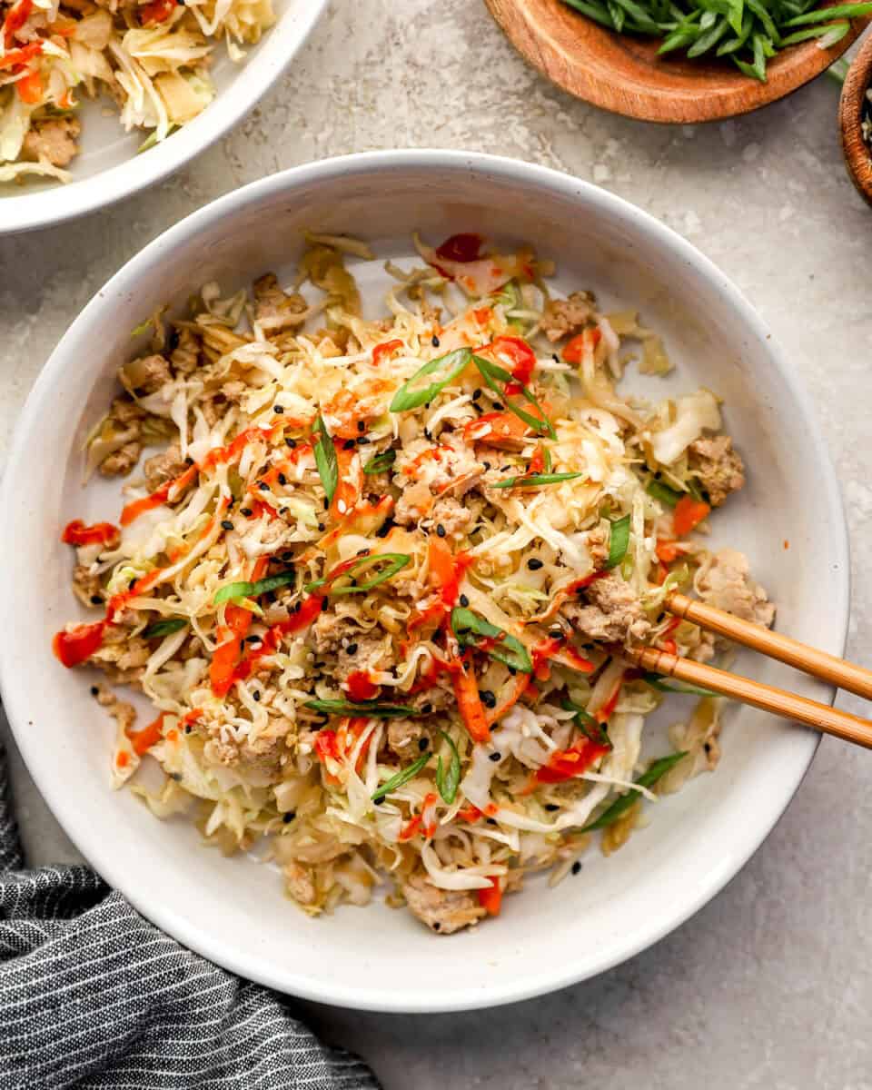 Chicken egg roll in a bowl with chopsticks.