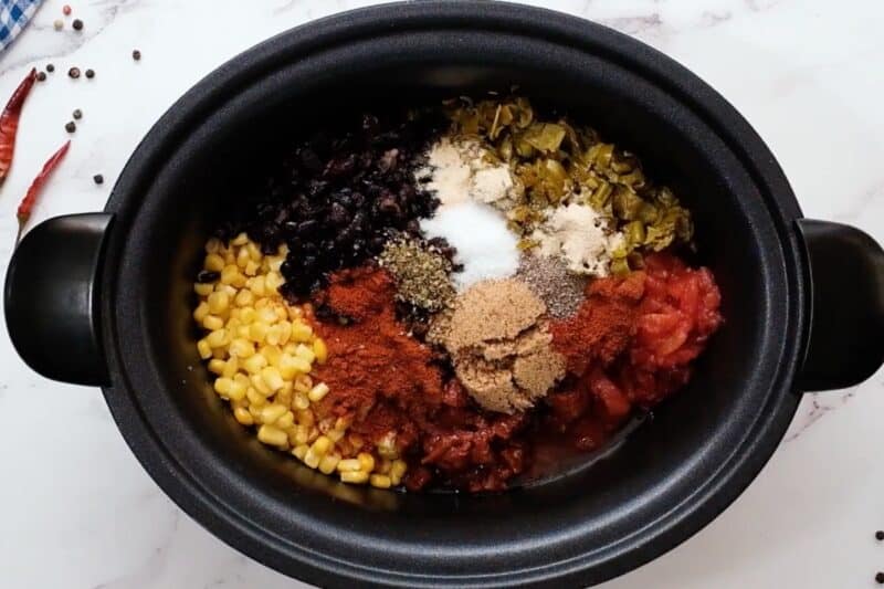 Mexican taco chicken ingredients in a Crockpot.