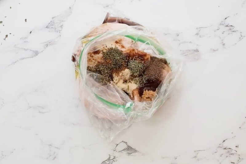 Chicken thighs and marinade ingredients in a resealable bag.