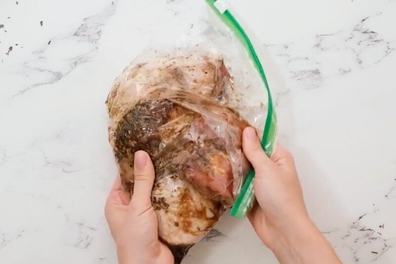 Chicken thighs marinating in a bag.