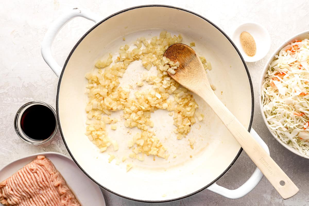 Onion, ginger and garlic cooking in a skillet.