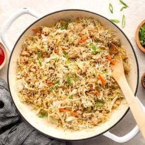 Coleslaw mix stirred into the skillet.
