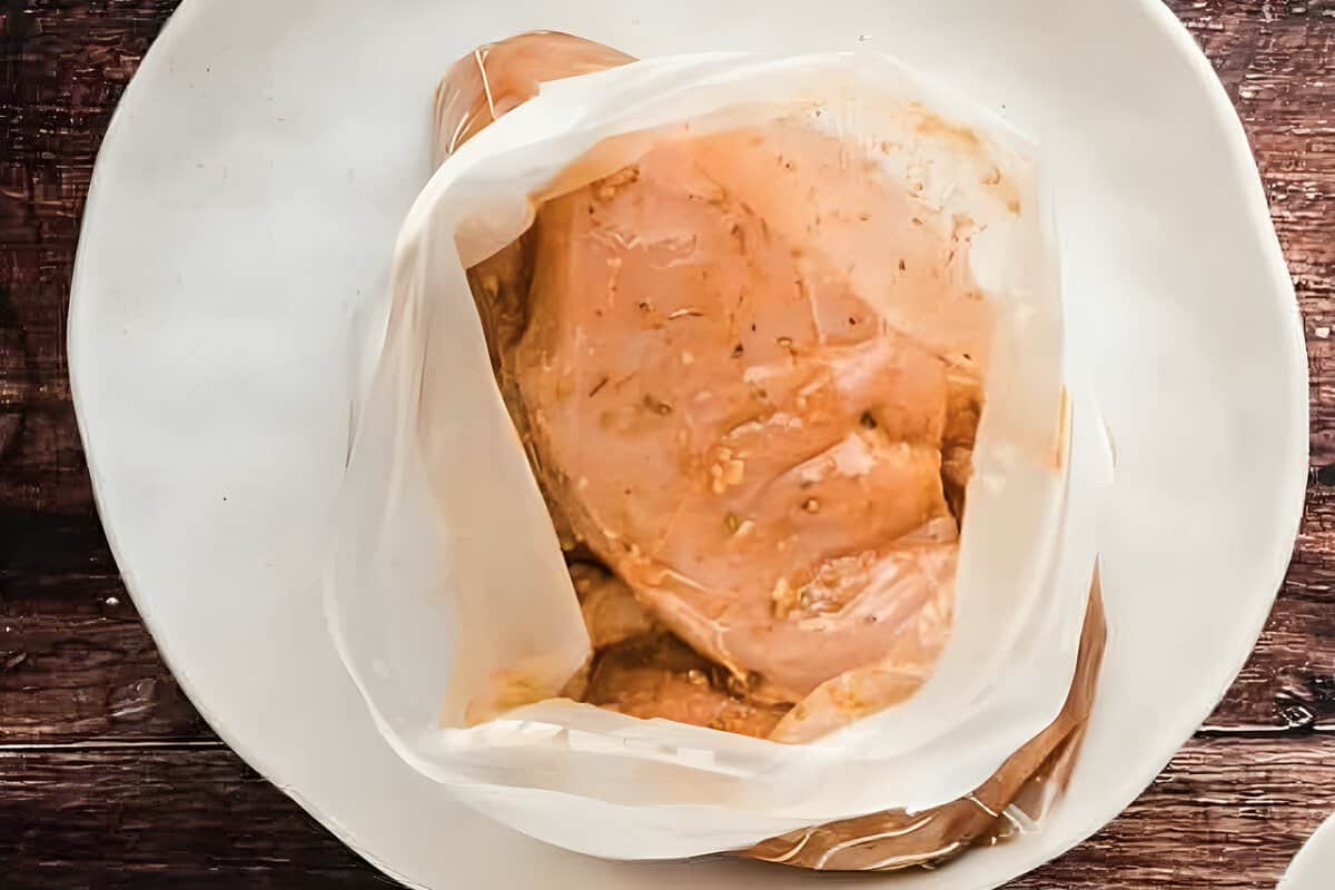 Chicken breasts marinating in a resealable bag.