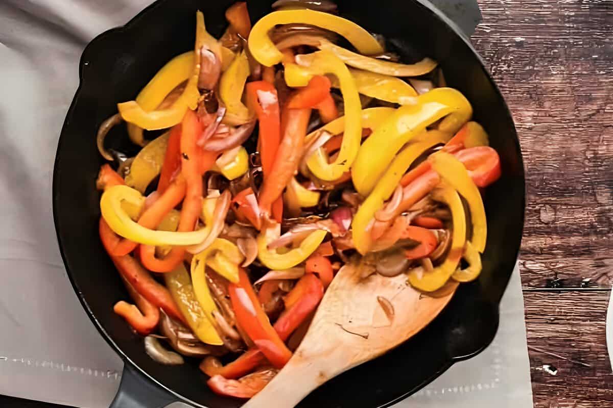 Fajita peppers cooking in a skillet.