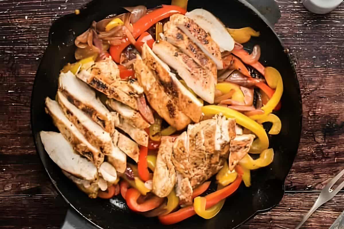 Chicken fajita mixture in a skillet.