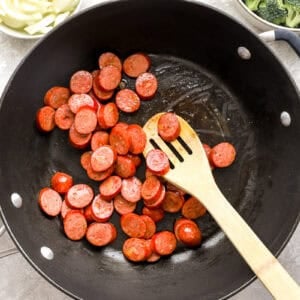Chicken sausage being browned in a skillet.