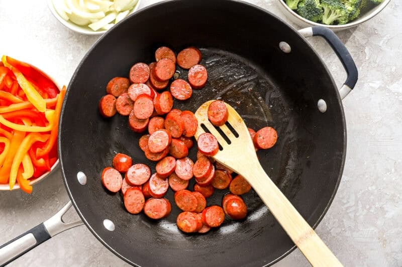 Chicken sausage being browned in a skillet.