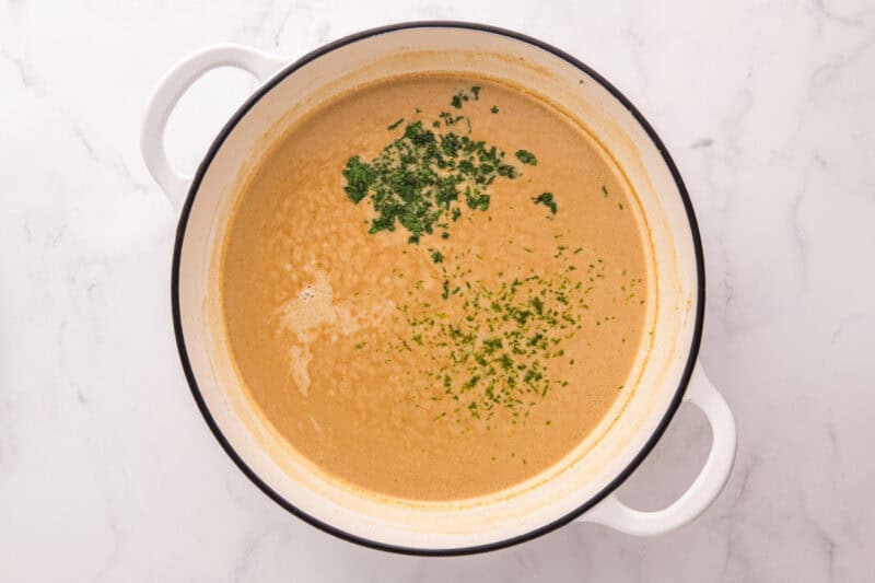 Fresh cilantro added to the thickened sauce.