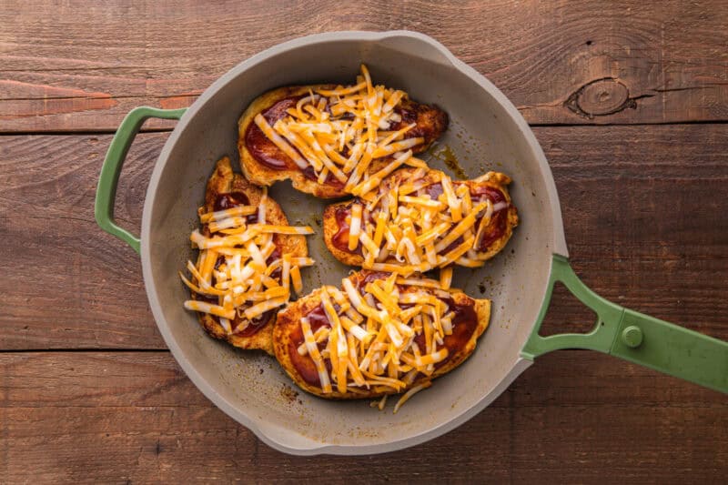Cheese added on top of the chicken and barbecue sauce.