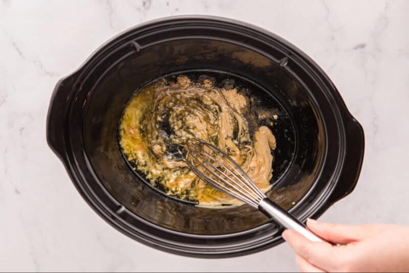 Whisking together ingredients in a Crockpot.