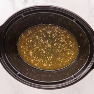 Whisked ingredients tin the slow cooker.