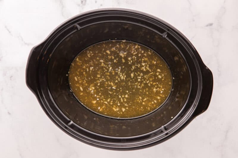 Whisked ingredients tin the slow cooker.