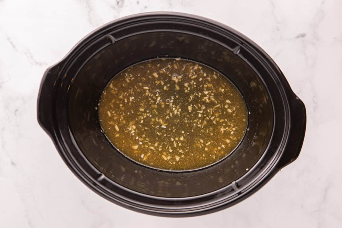Whisked ingredients tin the slow cooker.