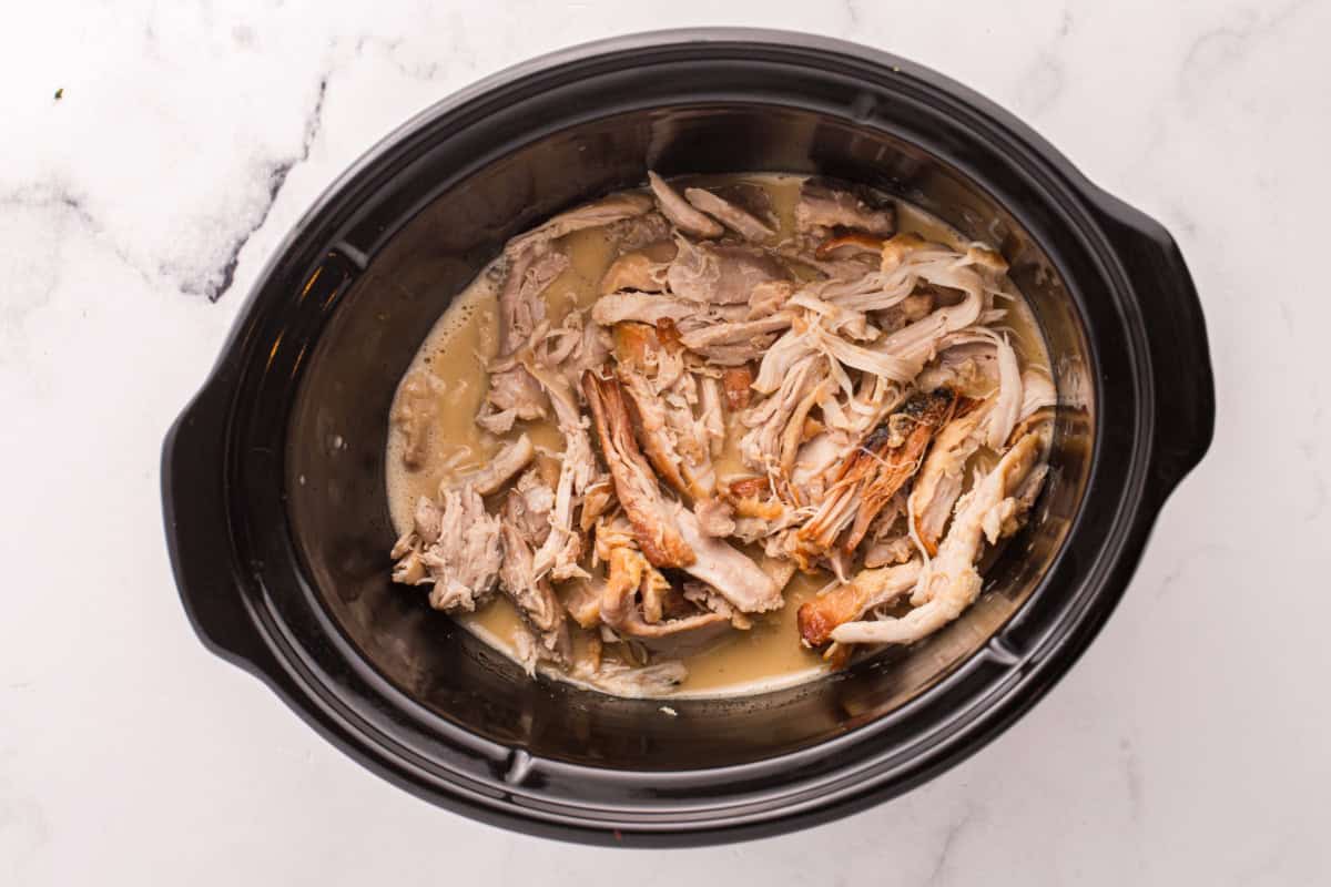 Shredded chicken thigh meat added to the slow cooker with honey mustard sauce.