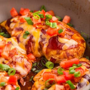 Monterey chicken garnished with bacon, tomatoes and green onions.
