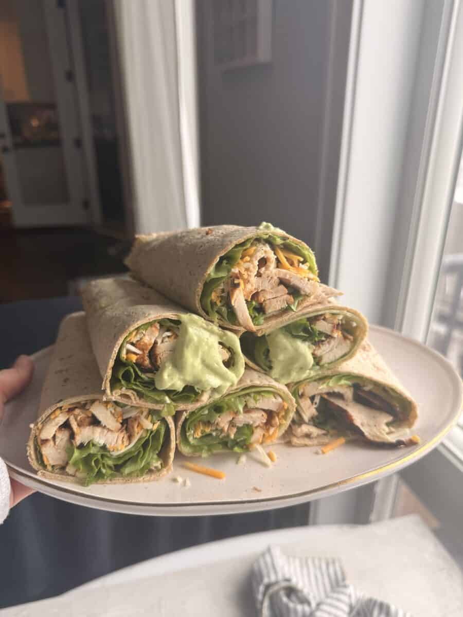 A plate of prepped chicken wraps.