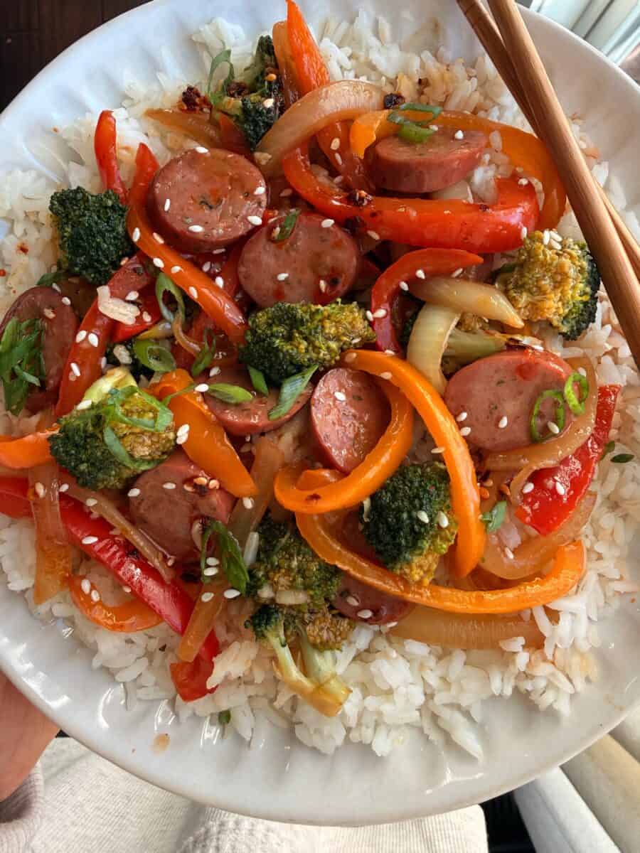 A plate of chicken sausage stir fry with white rice.