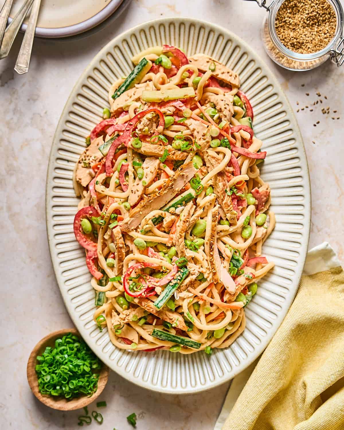 Cold Asian noodle salad with chicken served on a large plate.