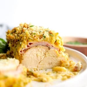 Crockpot chicken cordon bleu served on a white plate.