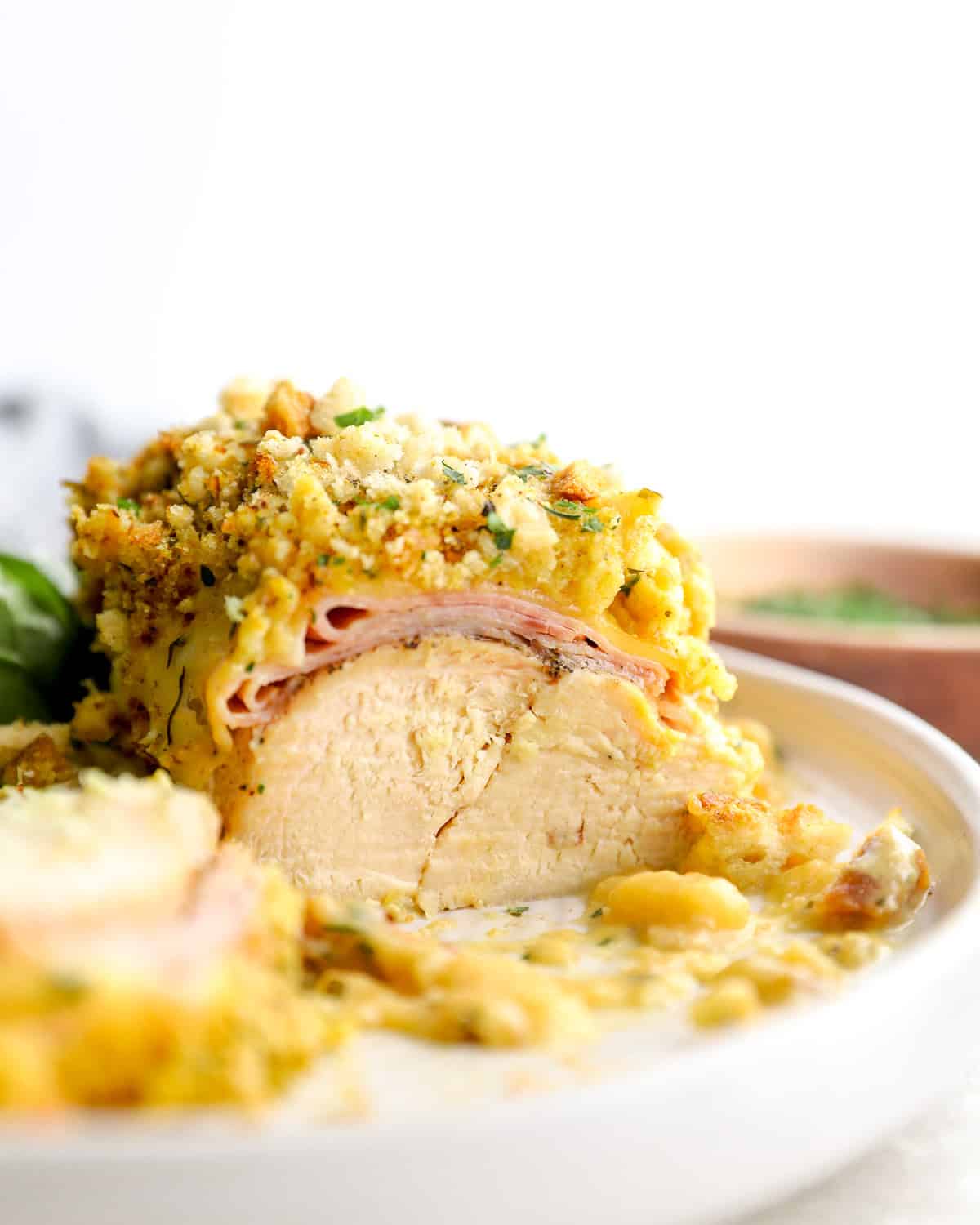 A serving of Crockpot chicken cordon bleu, with layers of ham, cheese, and stuffing.