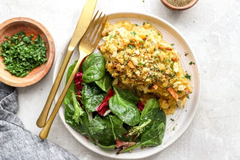 Chicken cordon bleu served on a plate with a green salad.