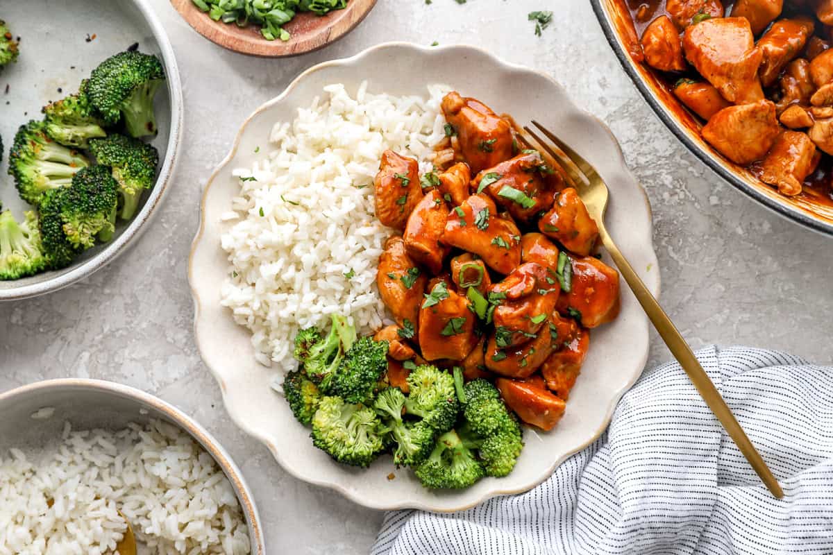 Diet cola chicken served on a plate with rice and broccoli.