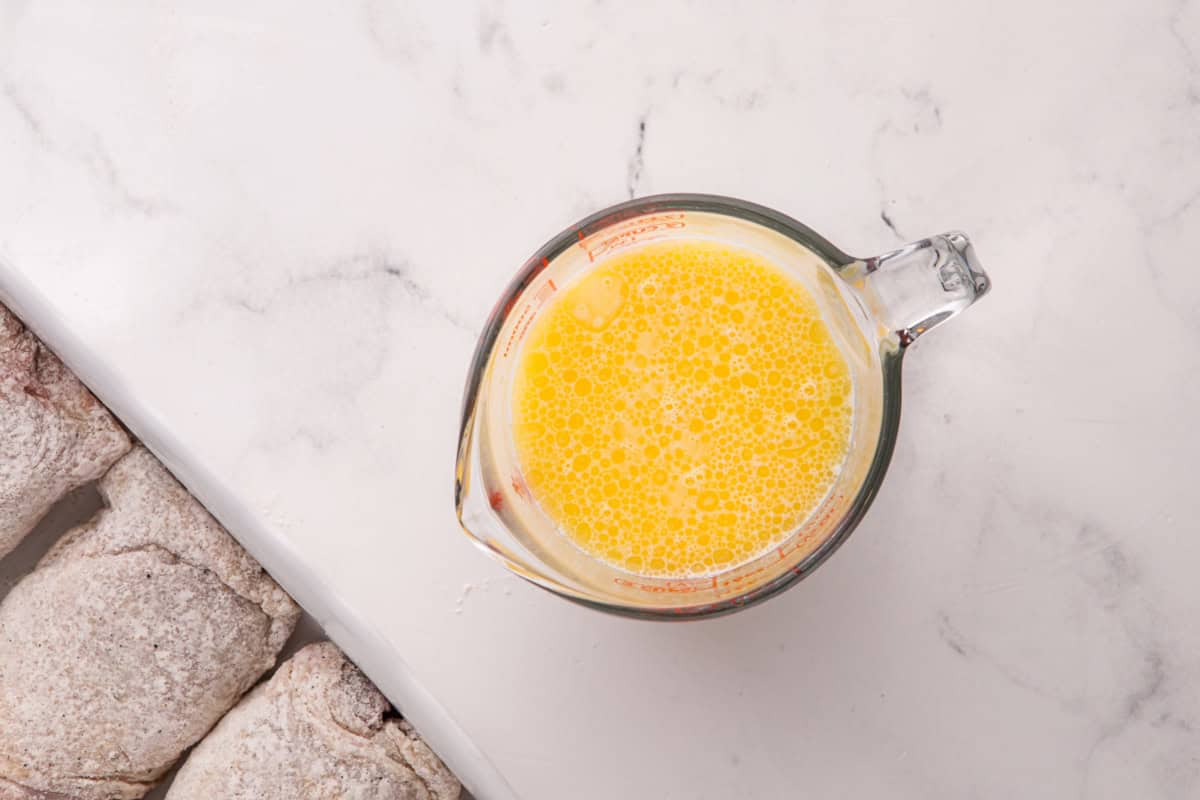 Broth, butter and cream mixed together in a glass jug.