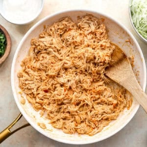 Shredded buffalo chicken in a skillet.