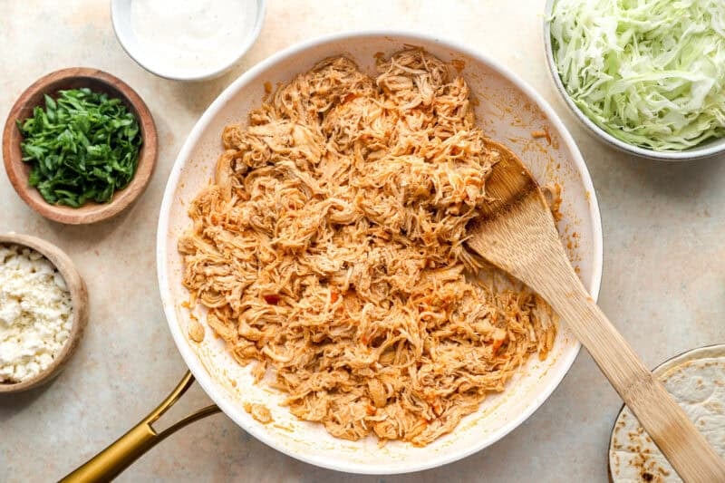 Shredded buffalo chicken in a skillet.