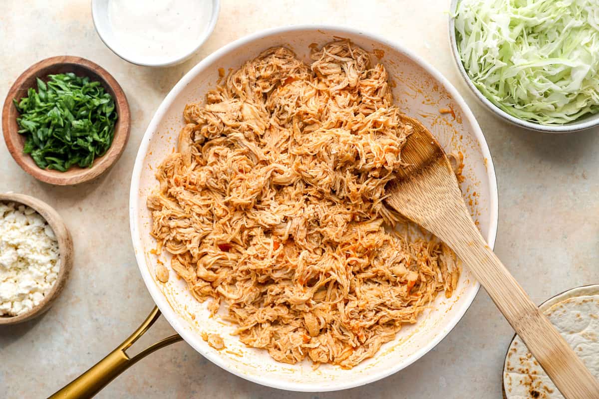 Shredded buffalo chicken in a skillet.
