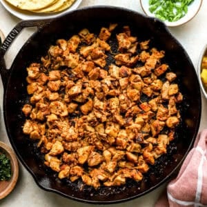 Chicken cooked in a skillet with the marinade.