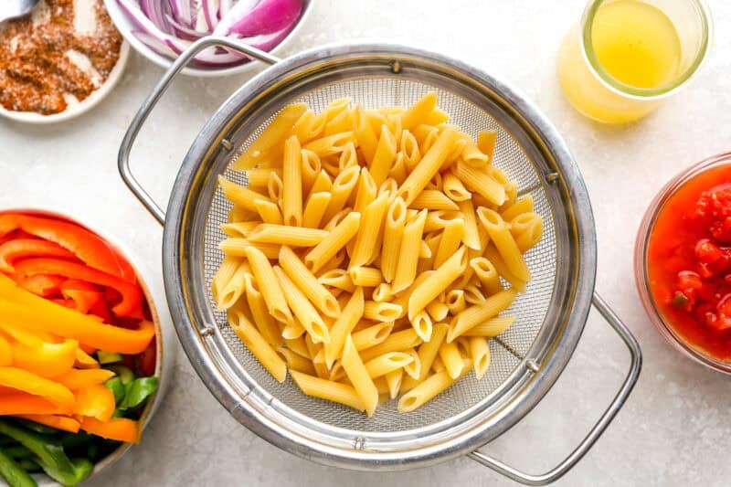 Cooked pasta in a sieve.