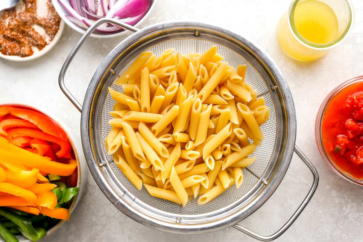 Cooked pasta in a sieve.