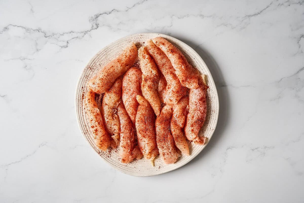 A plate of seasoned chicken tenders.