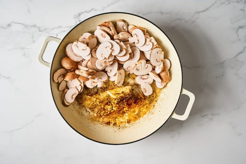 Mushrooms added to a pan.
