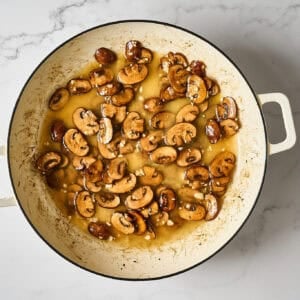 Chicken broth added to the mushrooms.