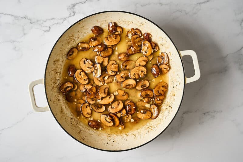 Chicken broth added to the mushrooms.