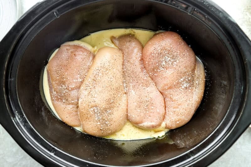 Soup mix and chicken breasts in the slow cooker.