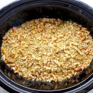 Stuffing mix sprinkled on top of the chicken in a Crockpot.