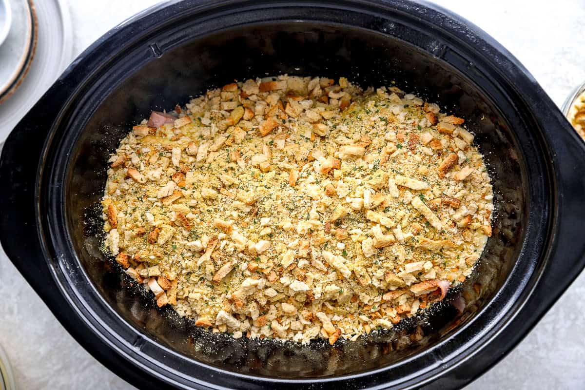 Stuffing mix sprinkled on top of the chicken in a Crockpot.